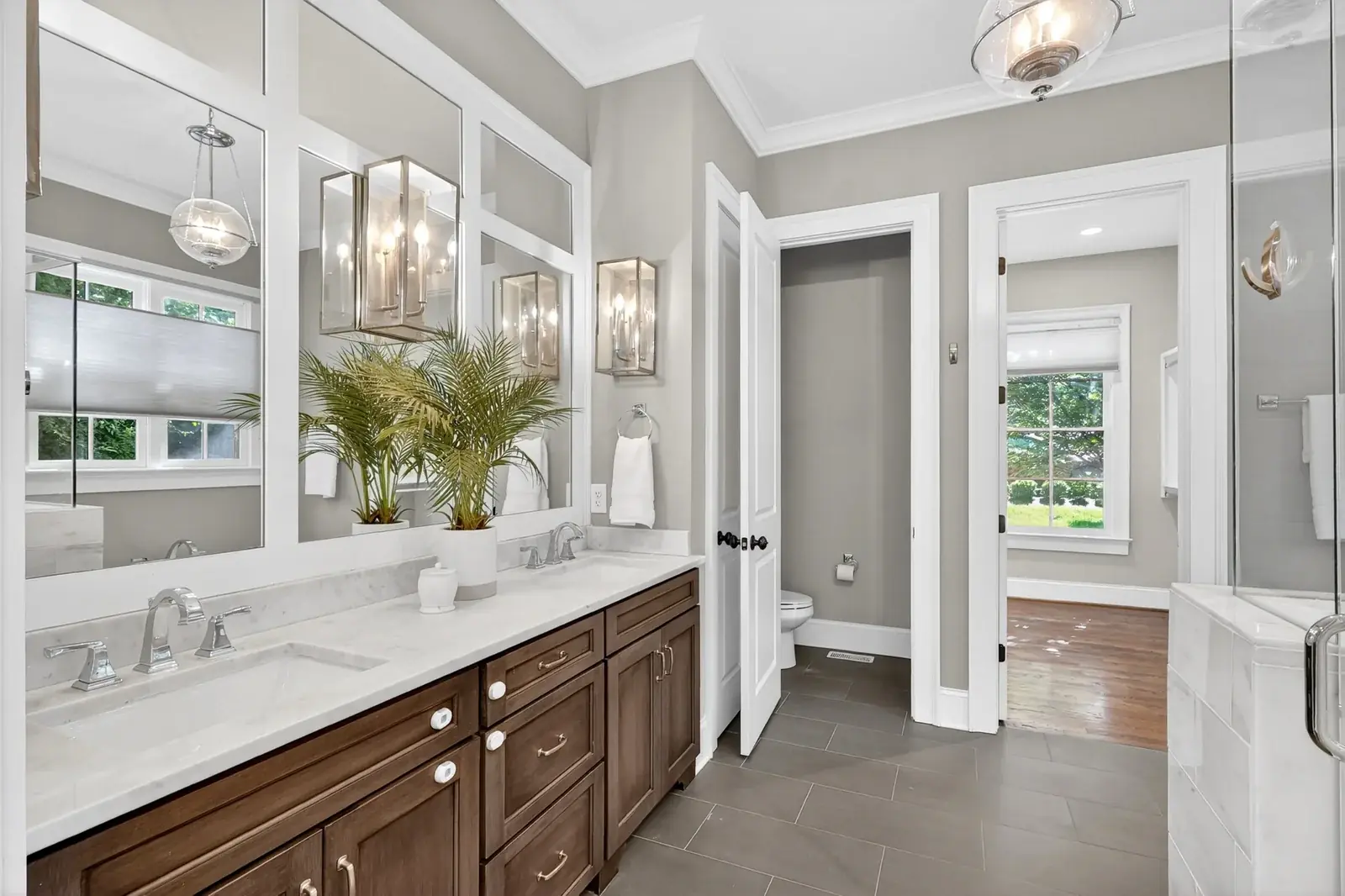 Primary bathroom with double vanity and marble counters