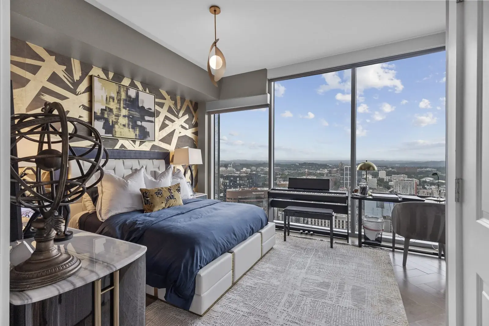 High-rise bedroom with floor-to-ceiling windows over the city