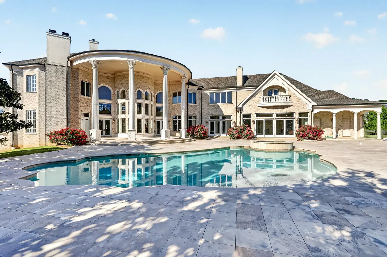 Estate rear elevation with columned portico and pool