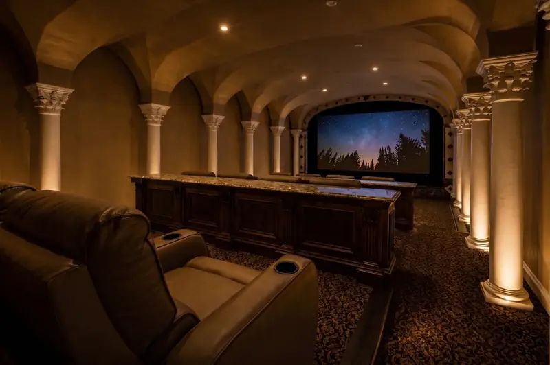 Home theatre with vaulted arches and tiered seating